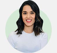 Nimi Daya Naran portrait with shoulder-length wavy dark hair and white top