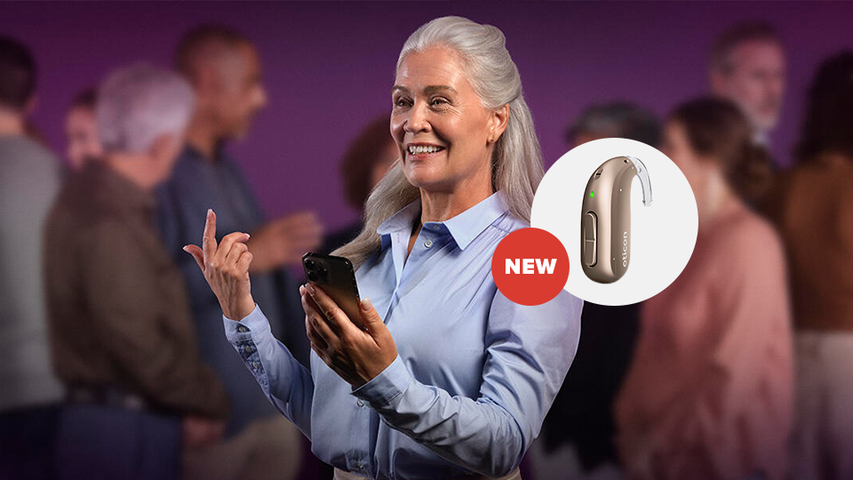 Woan holding Oticon MiniBTE-R hearing aid