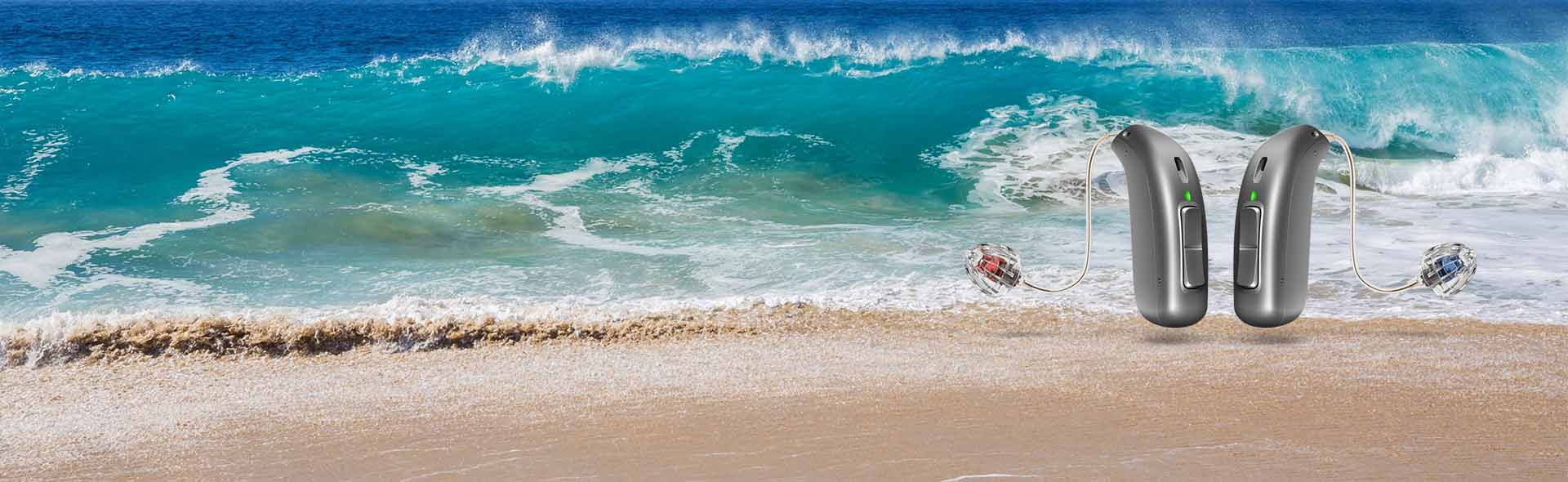 hearing aids for tinnitus relief placed against a serene beach wave background