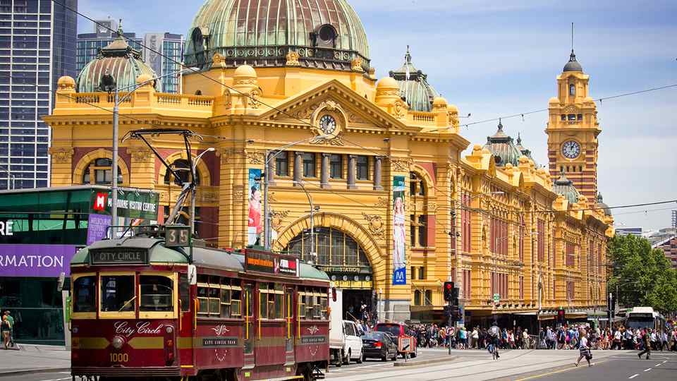Audiologist and woman sharing a laugh during a consultation in a hearing clinic.