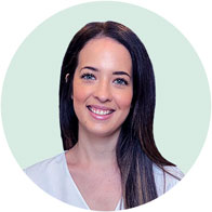 Woman with long dark hair against a light green background