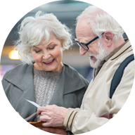 Senior couple reviewing a document together, emphasizing thoughtful hearing care solutions.