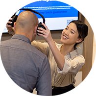 Audiologist fitting headphones on a patient during a hearing test in a clinic setting