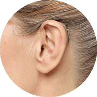Behind-the-ear hearing aid worn by an adult