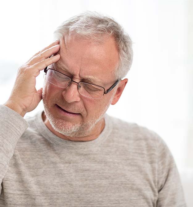man experiencing discomfort linked to tinnitus