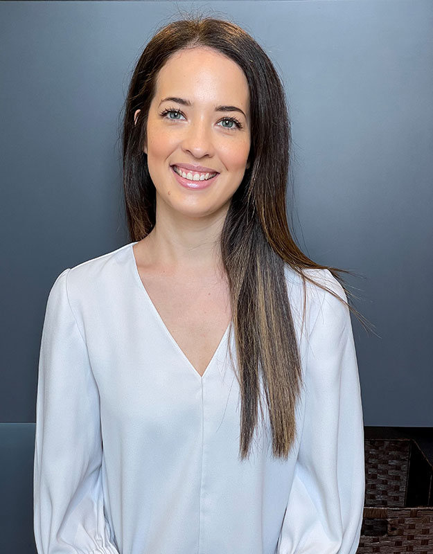 Maddison Franse, professional audiologist at a hearing care clinic, wearing a white blouse.