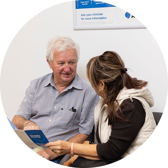 pensioner discussing hearing aid options with a hearing care professional