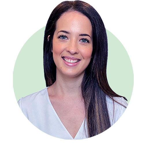 Clinician Maddison in a professional white blouse against a light green background.