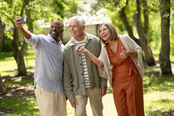 three_friends_taking_a_selfie_together_during_a_game_of_petanque
