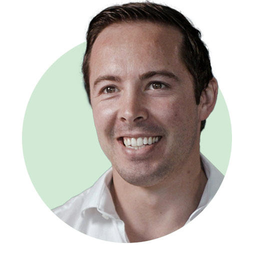 Smiling person wearing a white shirt against a light green background.