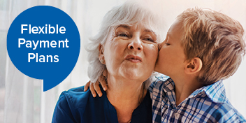 Grandmother and grandson embracing beside a speech bubble highlighting flexible payment plans.