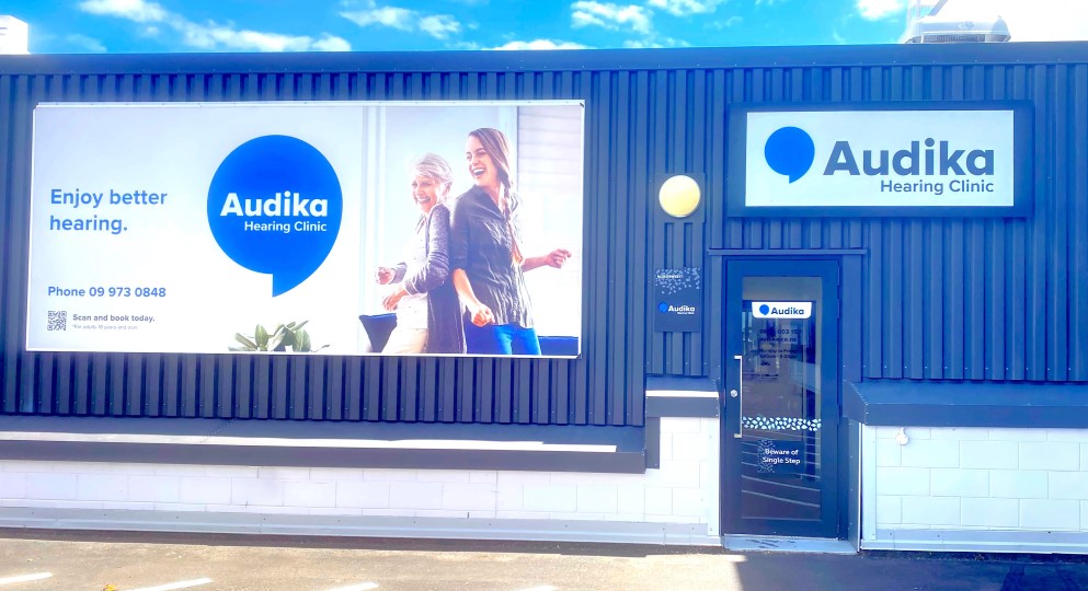 Audika Hearing Clinic exterior with signage and contact information promoting better hearing solutions.