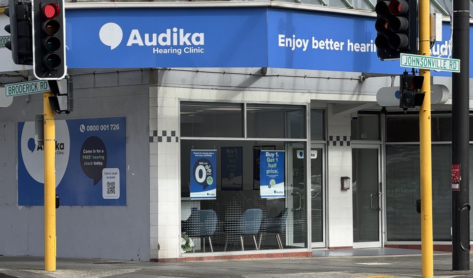 Audika Hearing Clinic located at the intersection of Johnsonville Road and Broderick Road in Wellington featuring promotional offers for free hearing checks and discounted hearing aids.