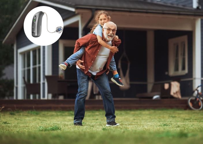 Happy_grandad_playing_in_garden_jetpx_hearing_aid_inset