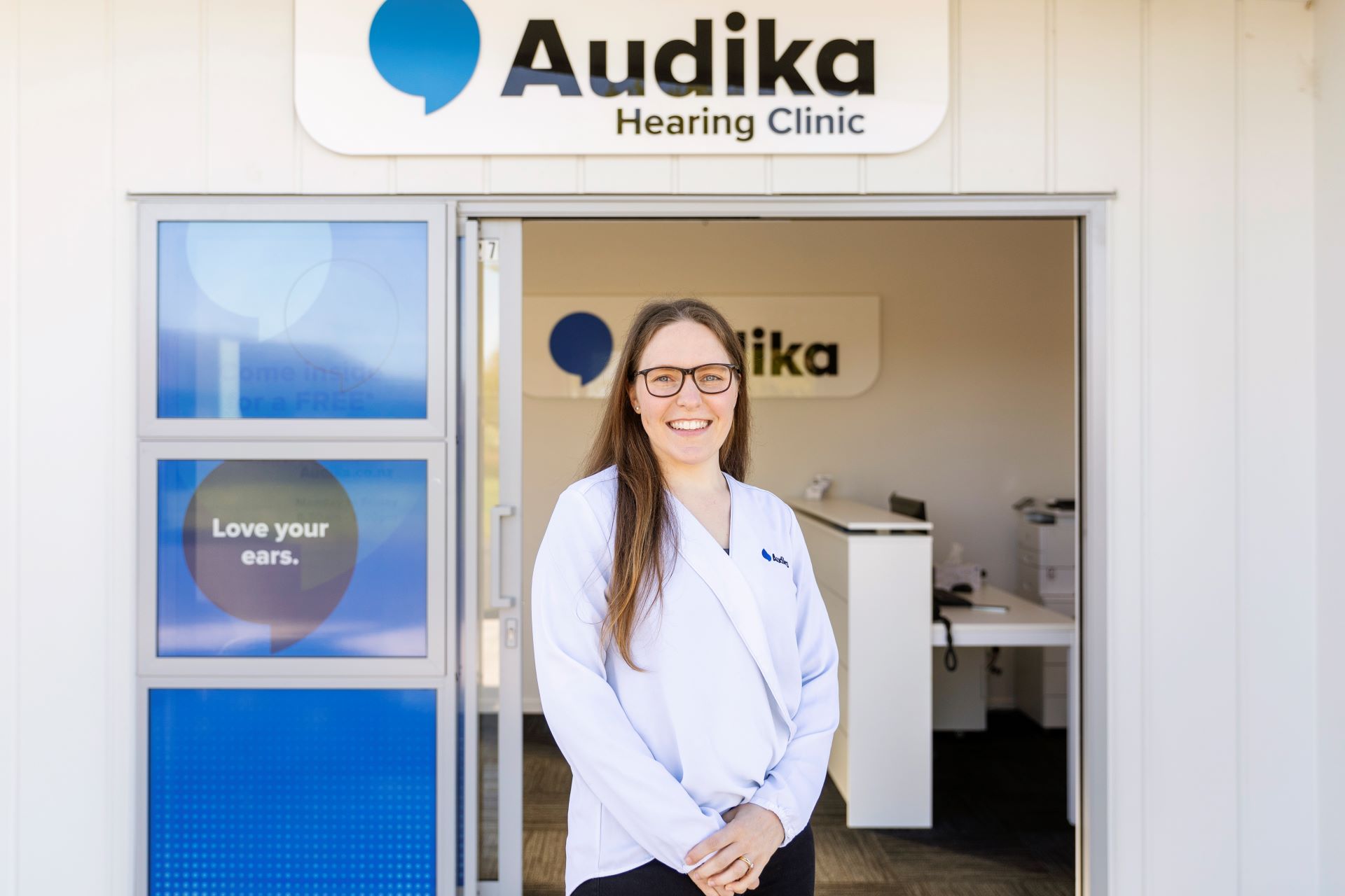 Audiologist standing outside Audika Hearing Clinic