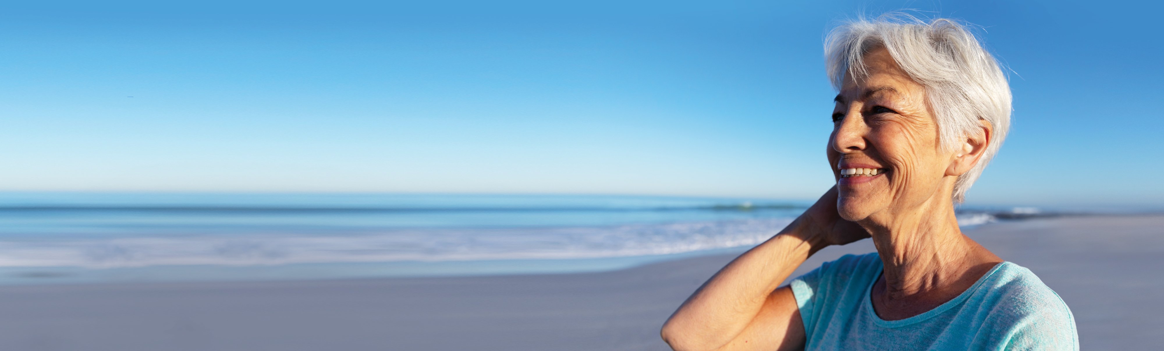 Woman_smiling_on_long_deserted_beach