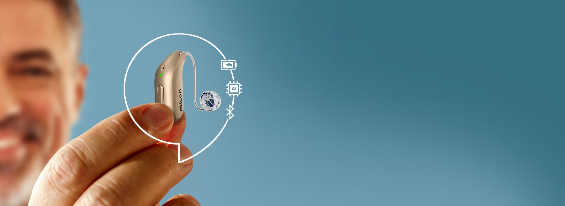 man_in_background_holding_hearing_aid_in_the_foreground_with_graphics_around_the_hearing_aid_showing_rechargability_AI_technology_and_bluetooth_connectivity