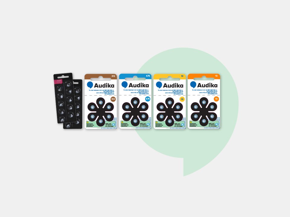 Audika hearing aid batteries in sizes 312, 675, 10, and 13 alongside packs of domes.