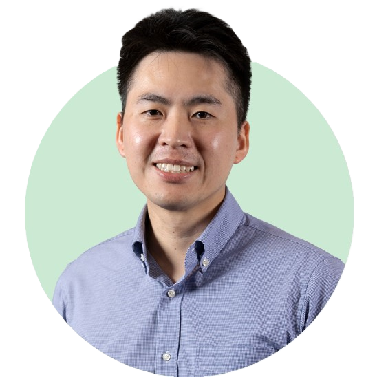 Author wearing a light purple checkered shirt against a light green circular background.