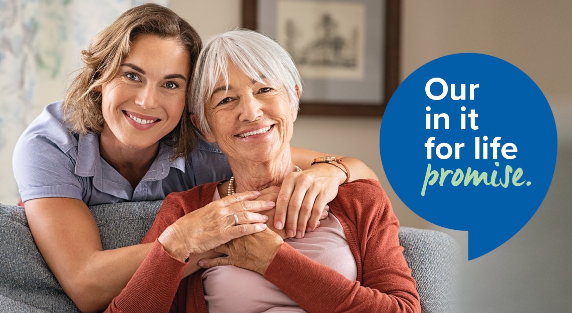 Woman_leaning_over_sofa_embracing_older_woman