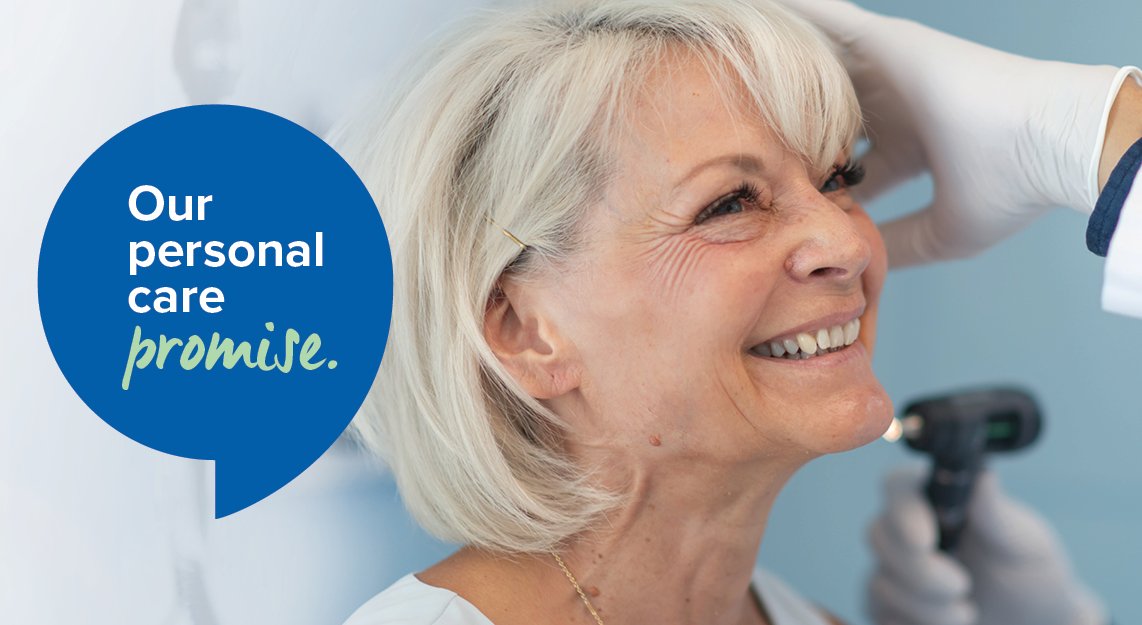 Smiling_woman_getting_otoscopy_of_ear