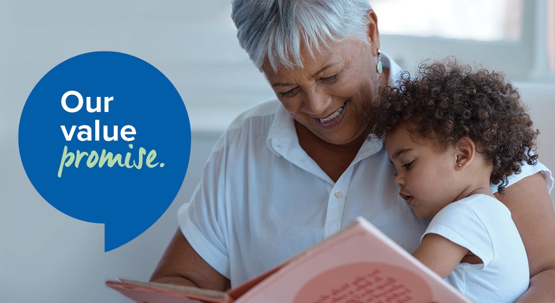 Grandmother_smiling_reading_to_child_sitting_on_her_lap