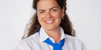 Hearing care professional wearing a white shirt and blue tie