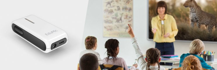 Teacher using EduMic device in a classroom setting while students raise hands.