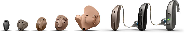 Different types of hearing aids arranged in a row, including in-the-ear, behind-the-ear, and receiver-in-canal styles.