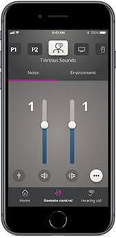 A smartphone displaying a hearing aid control app interface. The app adjusts ’Tinnitus Sounds,’ showing sliders labeled ’Noise’ and ’Environment’ set at level 1. Buttons include ’Home,’ ’Remote Control,’ and ’Hearing Aid.’