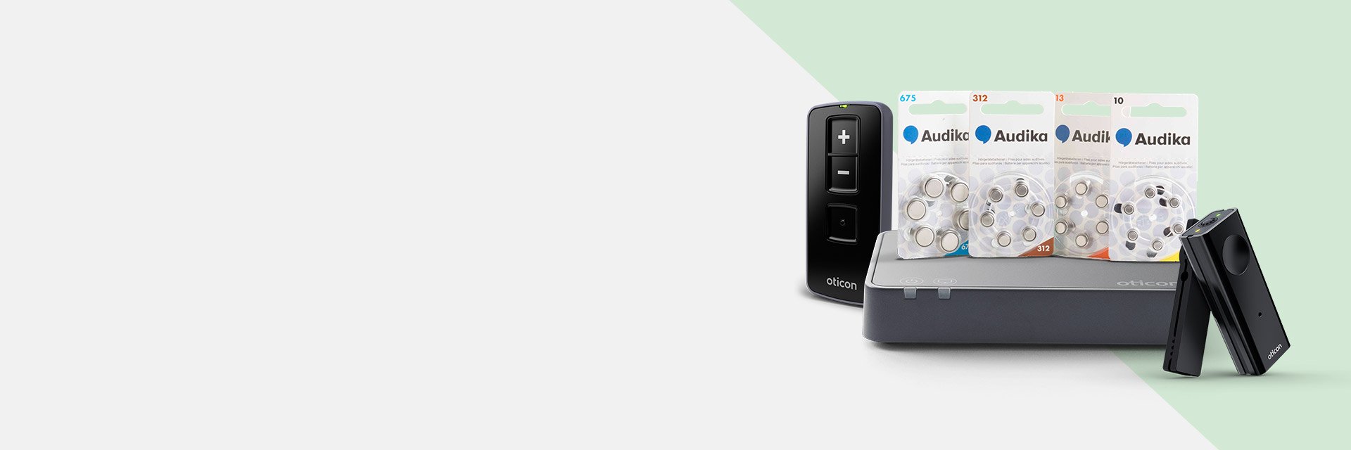 Hearing aid accessories including remote controls, battery packs, and a wireless streaming device.