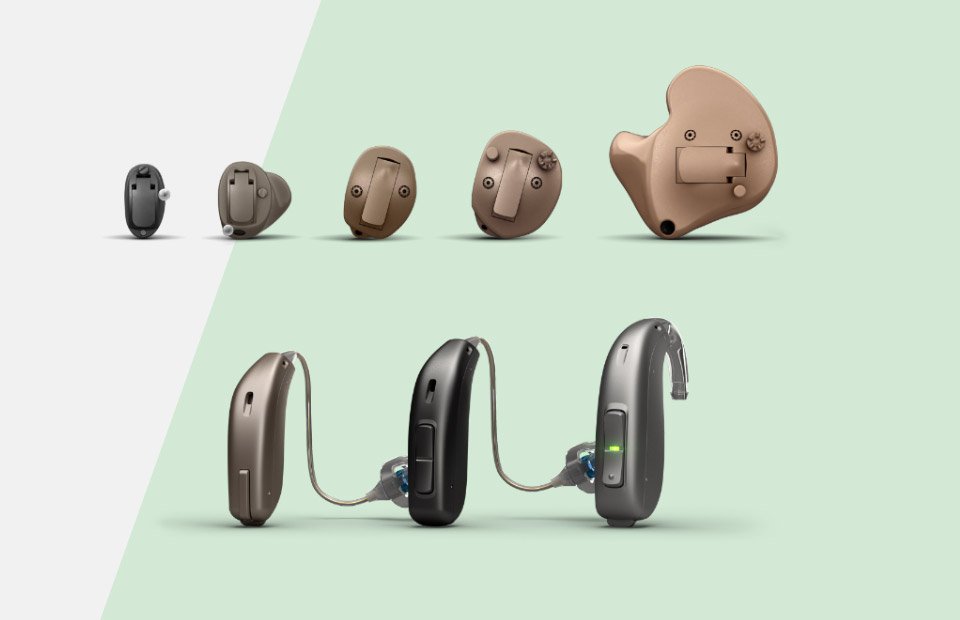 Hearing aids from various brands, including behind-the-ear and in-the-ear models, displayed against a light background.