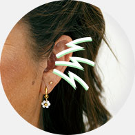 Image shows woman holding head suffering from pain
