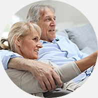 Image shows elderly couple watching televison