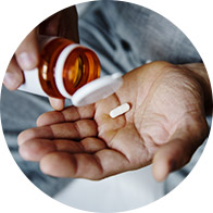 Image shows hand holding some medication