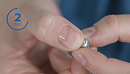 Changing programs on behind-the-ear miniRite hearing aids by pressing the button for two seconds