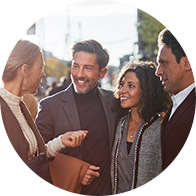 Group of people conversing outdoors in casual attire