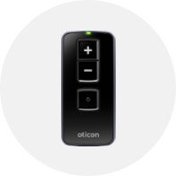 Oticon hearing aid remote control with volume adjustment and program selection buttons.