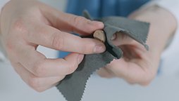 Cleaning Oticon in-the-canal custom hearing aids using a microfiber cloth