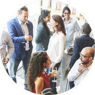People engaging in lively group conversations at a social gathering.