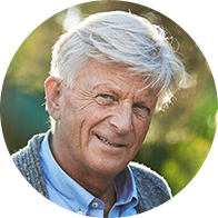 Elderly man with white hair enjoying a sunny day outdoors
