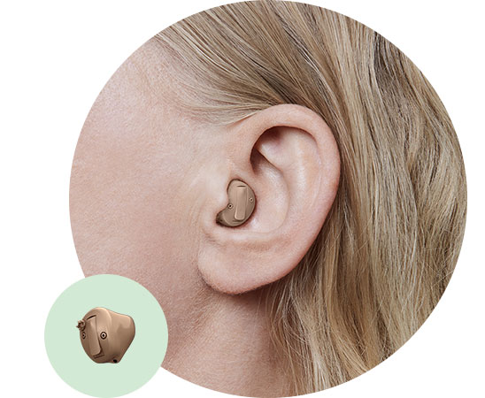 In-the-canal hearing aid worn in a person’s ear, showcasing its discreet and ergonomic design.