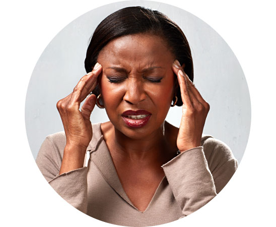 Image shows woman holding her head due to pain