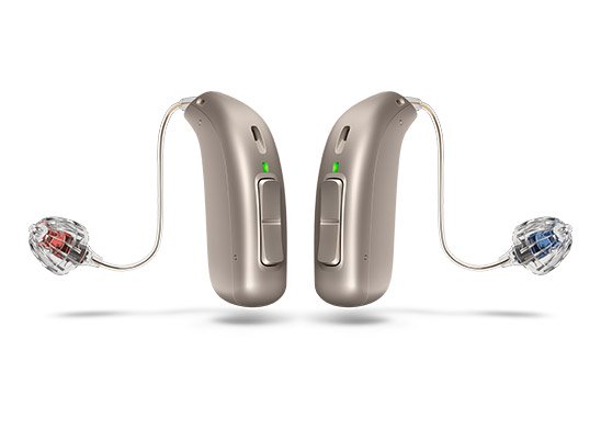Modern hearing aids with sleek design, featuring red and blue earpieces for left and right ears, used as an effective hearing loss solution.
