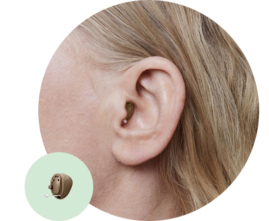 Completely-in-the-canal hearing aid positioned discreetly in a person’s ear.
